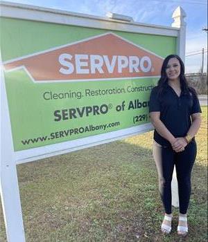 Woman in front of signage wearing a SERVPRO Shirt