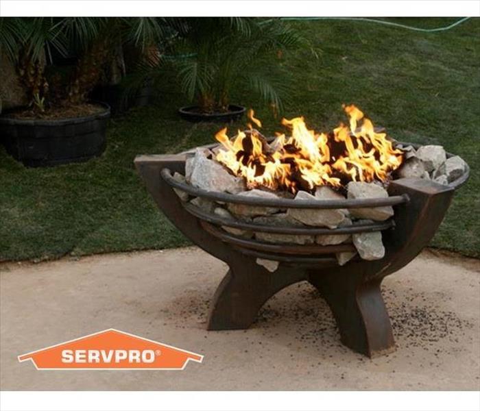 Photo of an outdoor fire pit with SERVPRO logo