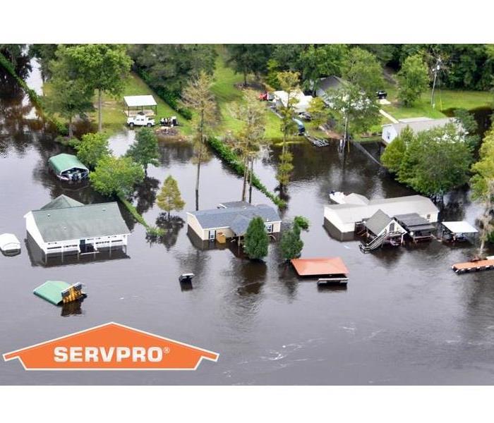 Flooded neighborhood with SERVPRO logo