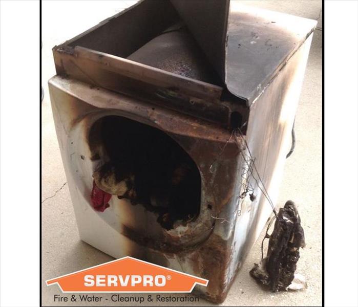 Burned clothes dryer with SERVPRO logo