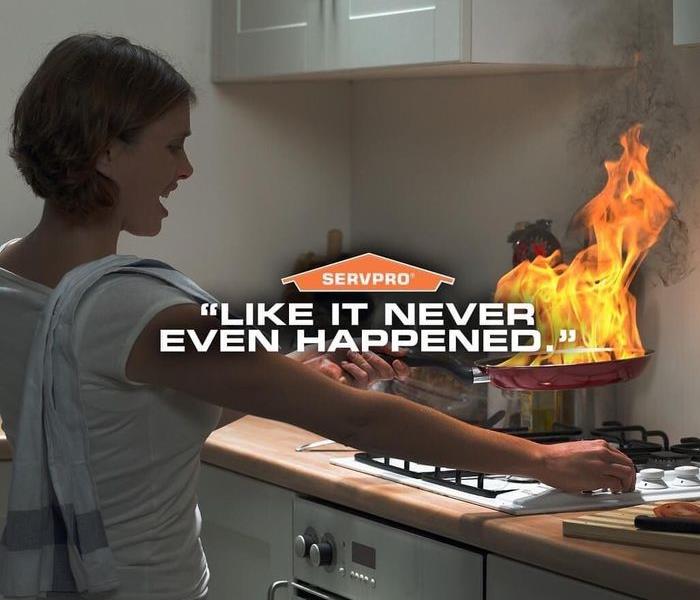 woman cooking in kitchen. Pan is on fire. She is in panic trying to turn it off.